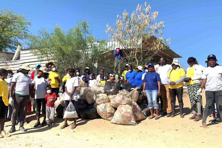 DWN volunteers pose with locals after a community clean up event.